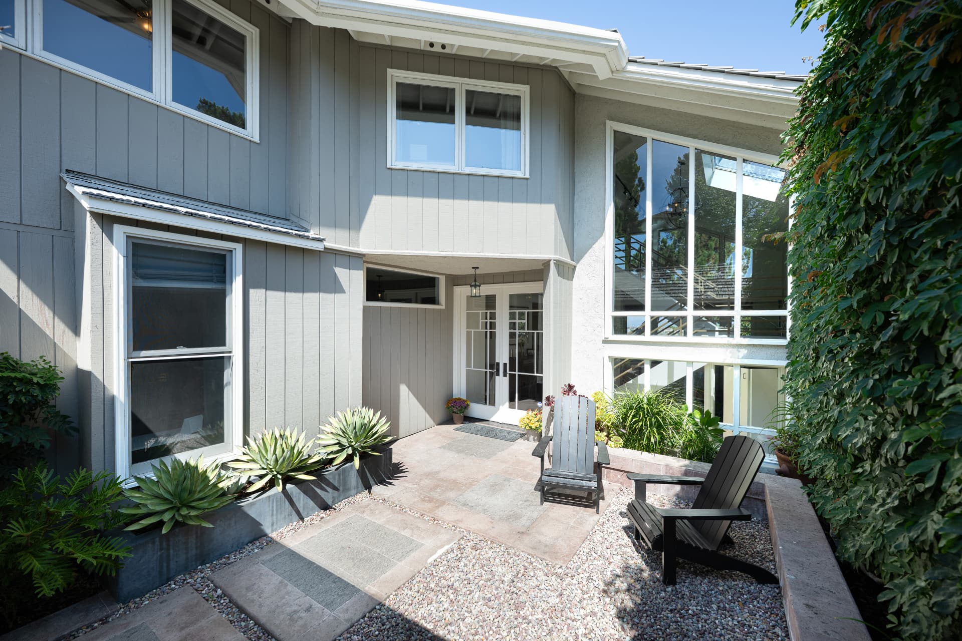 Sunlit front entry courtyard with seating area