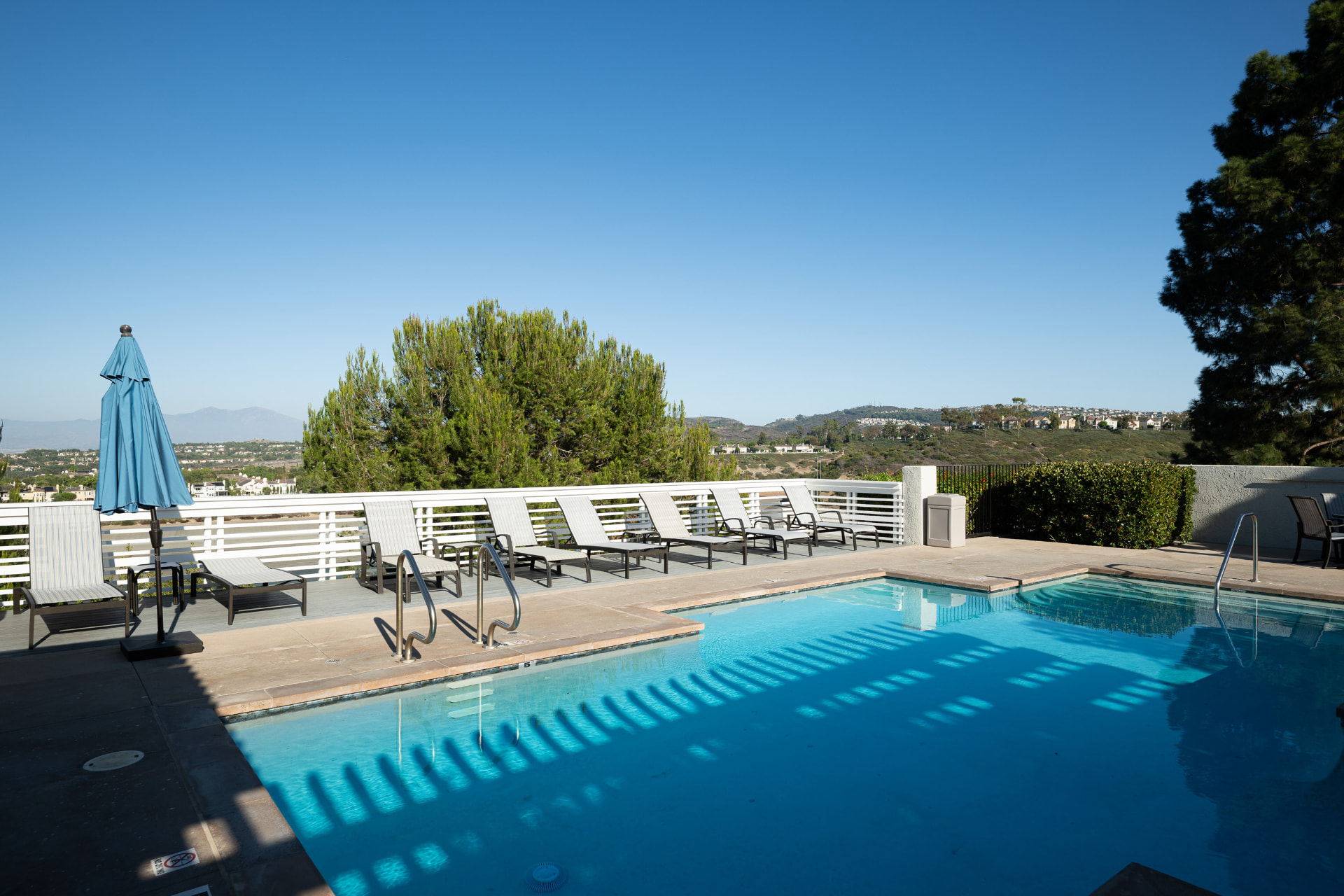 Community pool and spa with loungers above the open hillsides
