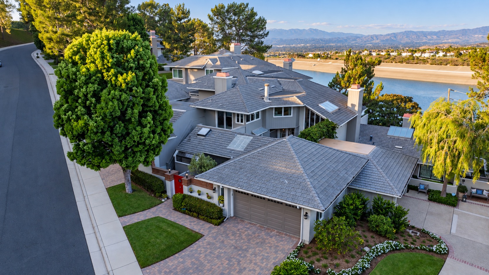 Aerial view of 36 Vienna with the red gate, paver driveway, and San Joaquin Reservoir beyond